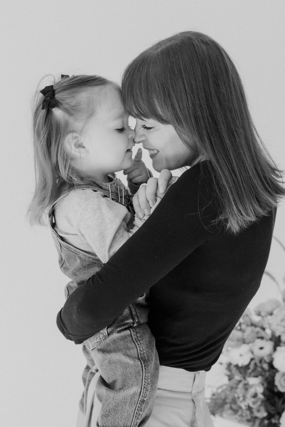 Mother and child touching foreheads nose-to-nose during a studio session